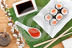 Red caviar, sushi set, sakura branch and green tea