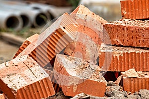 Red ceramic bricks at the construction site. Keramoblock. Hollow brick. Construction of a red brick building. Close-up. Material