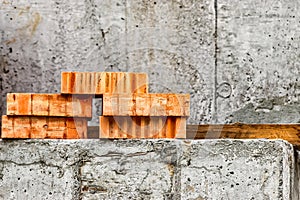 Red ceramic bricks at the construction site. Keramoblock. Hollow brick. Construction of a red brick building. Close-up. Material