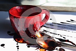 Red ceramic mug spoons and instant coffee  on a white table