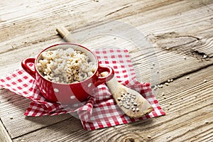 The red ceramic saucepan with white polka dots complete crumbly barley porridge