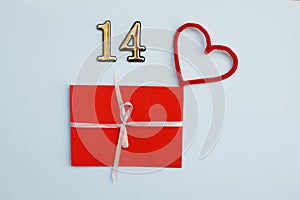 Red certificate with white bow and number 14 over it on the blue background. Romantic love letter for the Valentine`s day concept