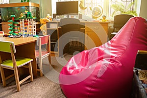 Red chair bag in children`s playroom