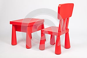 Red chair and red table for children in kindergarten preschool classroom