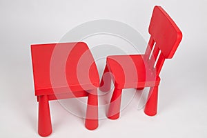 Red chair and red table for children in kindergarten preschool classroom