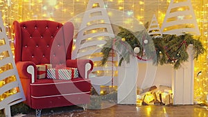 Red chair of Santa Claus or St. Nicholas with christmas gifts near fireplace and twinkling lights at the mall.
