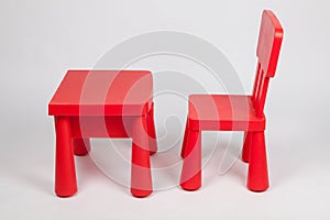 Red chair and red table for children in kindergarten preschool classroom