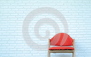 Red chair on white brick background,Modern room,copy space