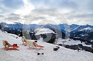 Red chairs against the backdrop of the mountains