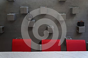 Red Chairs Against Stucco Wall