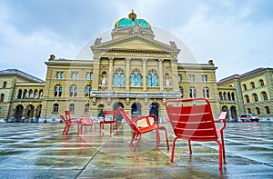The red chairs on Bundeshaus square at the Federal Palace building in Bern, Switzerland