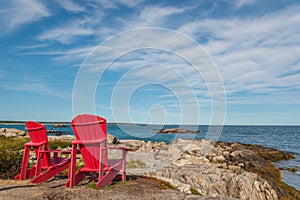 Red chairs facing Keji Seaside beach (South Shore, Nova Scotia,