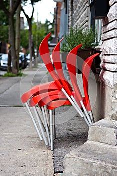 Red chairs lined up in a row outside