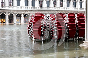 red chairs of a restaurant in Venice Italy with high water photo