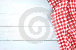 Red checked picnic towel cloth on blue wooden empty space background