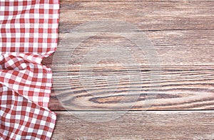 Red checked picnic towel cloth on wooden empty space background