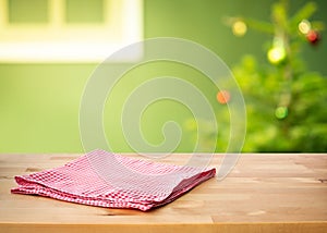 Red checked tablecloth on wood with christmas tree,decoration