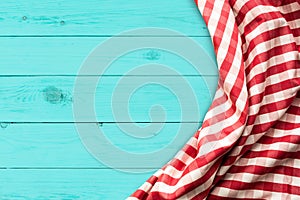 Red checkered fabric on blue wood table background.For decoration key visual l