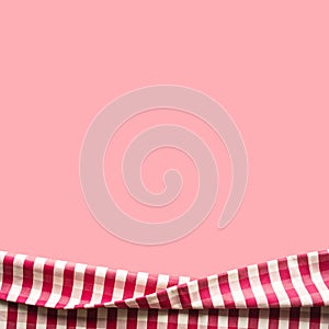 Red checkered fabric on pink color background