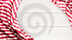 Red checkered fabric on white wood table background.For decoration key visual