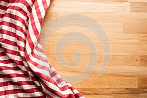 Red checkered fabric on wood table background.For decoration key visual