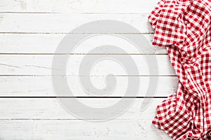 Red checkered kitchen tablecloth on wooden table