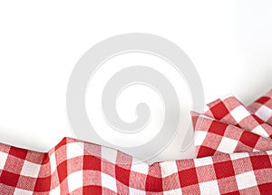 Red checkered picnic cloth folded top view on white background. Gingham crumpled towel empty copy space.Kitchen napkin