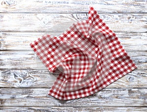 Red checkered picnic cloth top view on rustic wooden background empty copy space