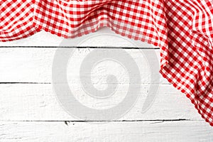 Red checkered tablecloth on white wooden table.