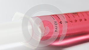 Red chemical medicine in syringe. vaccine study photo