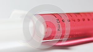 Red chemical medicine in syringe. vaccine study photo