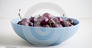 Red cherries in antique bowl