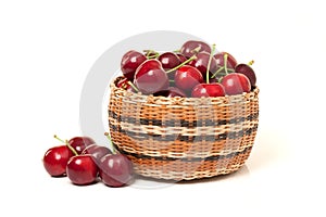 Red Cherries in a basket on white background