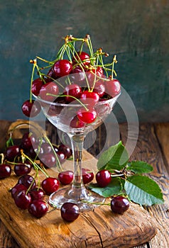 red cherries in a glass jar, on a wooden table, country atmosphere, ia generated