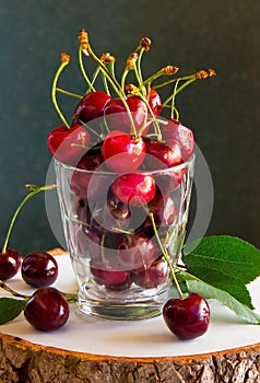 red cherries in a glass jar, on a wooden table, country atmosphere, ia generated