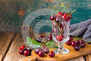 red cherries in a glass jar, on a wooden table, country atmosphere, ia generated