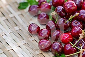Red cherries on a wooden surface. Juicy cherries in the orchard in a summer day. Sweet fruits. Shallow depth of field. Toned image