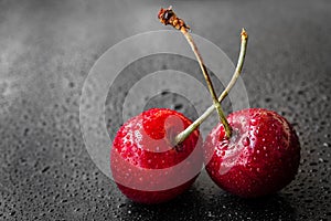 Red cherry berries in water drops