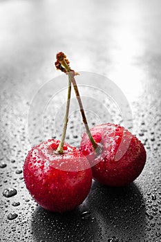 Red cherry berries in water drops