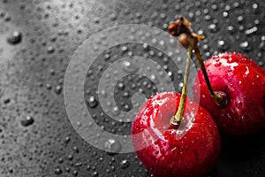 Red cherry berries in water drops