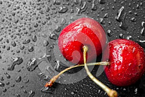 Red cherry berries in water drops