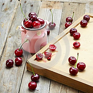 Red cherry in bowl on wooden table