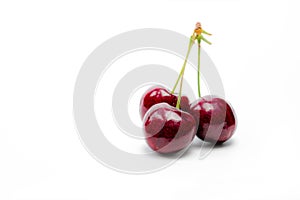 Red cherry with stalk isolated on white background. Ripe red sweet cherry. Sweet and juicy organic cherry. Fresh fruit for summer
