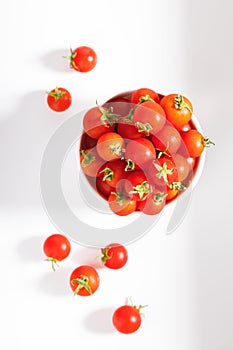 Red cherry tomato in  ceramic bowl on white background