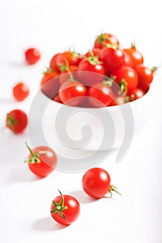 Red cherry tomato in  ceramic bowl on white background