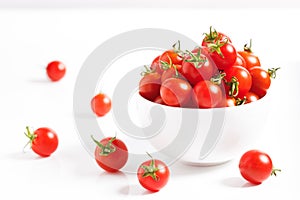 Red cherry tomato in  ceramic bowl on white background