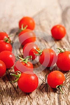 Red cherry tomato on wooden background