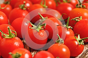 Red cherry tomato on wooden background