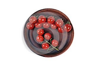 Red cherry tomatoes on a branch on a clay plate. Top view