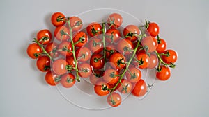 Red cherry tomatoes on a branch, washed with water.